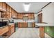 The kitchen features stainless appliances, wood cabinets, durable countertops, and tile flooring at 415 Southmoor Cir, Stockbridge, GA 30281