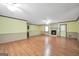 Open-concept living room with a stone fireplace, ceiling fans, and wood-look flooring at 415 Southmoor Cir, Stockbridge, GA 30281