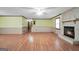 Spacious living room featuring wood floors, a stone fireplace, and wainscoting at 415 Southmoor Cir, Stockbridge, GA 30281
