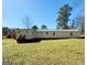 Wide shot of backyard showcasing the back exterior of the home with an expansive yard at 36 Reese St, Grantville, GA 30220