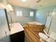 The bathroom is updated with stone-look accents, updated vanity, and tub shower at 36 Reese St, Grantville, GA 30220
