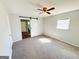 A serene bedroom with a sliding barn door to an en suite bathroom at 36 Reese St, Grantville, GA 30220