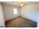 Cozy bedroom featuring neutral walls, ceiling fan, and natural light from the window at 36 Reese St, Grantville, GA 30220