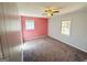 Bright bedroom with painted accent wall, carpet, and a ceiling fan for added comfort at 36 Reese St, Grantville, GA 30220