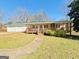 Charming single-story home with a welcoming front porch, green lawn, and a detached two-car garage at 36 Reese St, Grantville, GA 30220