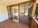 Enjoy relaxing views from this screened-in porch with wooden floors and ceiling with a swing at 36 Reese St, Grantville, GA 30220