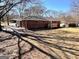 The brick house has a well-manicured lawn and a deck in the backyard at 1209 Topaz Ln, Villa Rica, GA 30180