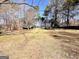 Expansive backyard featuring mature trees and grass at 1209 Topaz Ln, Villa Rica, GA 30180