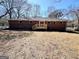 View of the brick home's backyard featuring a new wooden deck and large yard space at 1209 Topaz Ln, Villa Rica, GA 30180