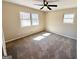 Bedroom features neutral paint, two windows and ceiling fan at 1209 Topaz Ln, Villa Rica, GA 30180