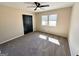 A bright bedroom features fresh paint, a ceiling fan, and large window allowing for ample light at 1209 Topaz Ln, Villa Rica, GA 30180