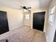 A bright bedroom features fresh paint, a ceiling fan, and large window allowing for ample light at 1209 Topaz Ln, Villa Rica, GA 30180