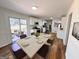 Bright dining room features a sleek table set, hardwood floors, and sliding glass doors to the outdoor patio at 1209 Topaz Ln, Villa Rica, GA 30180