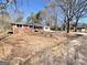 Spacious lot showcasing the side and back exterior of the brick home with ample yard space at 1209 Topaz Ln, Villa Rica, GA 30180