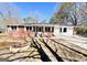 Charming brick home featuring a well-maintained front yard with a circular fire pit and spacious driveway at 1209 Topaz Ln, Villa Rica, GA 30180