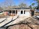 View of the exterior elevation displaying a combination of brick and siding, plus an expansive driveway at 1209 Topaz Ln, Villa Rica, GA 30180