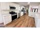 Updated kitchen boasts stainless steel appliances, white cabinets, and gleaming countertops at 1209 Topaz Ln, Villa Rica, GA 30180