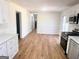 Bright and spacious kitchen featuring an abundance of white cabinets, stainless appliances and wood floors at 1209 Topaz Ln, Villa Rica, GA 30180