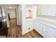 Kitchen view looking into an additional room with cabinets and modern stainless refrigerator at 1209 Topaz Ln, Villa Rica, GA 30180