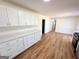 Modern kitchen featuring white cabinetry with gold hardware, hardwood floors and plenty of counter space at 1209 Topaz Ln, Villa Rica, GA 30180
