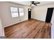 Living room showcasing hardwood floors and neutral walls plus a black accent door and modern lighting at 1209 Topaz Ln, Villa Rica, GA 30180