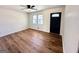 Bright living room with hardwood floors, neutral paint, and a modern ceiling fan for added comfort at 1209 Topaz Ln, Villa Rica, GA 30180