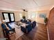 Beautifully furnished living room with brick wall, multiple windows, and stylish decor at 1209 Topaz Ln, Villa Rica, GA 30180