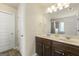 Bright bathroom featuring double vanity with solid surface countertop and framed mirror at 536 Caledon Way, Hampton, GA 30228