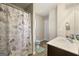 Bright bathroom featuring a vanity with solid surface countertop and decorative shower curtain at 536 Caledon Way, Hampton, GA 30228