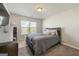 Bedroom with neutral-colored walls, and a queen bed bathed in natural light at 536 Caledon Way, Hampton, GA 30228