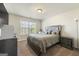 Bedroom featuring tufted headboard, carpet flooring, a dresser and large picture window at 536 Caledon Way, Hampton, GA 30228