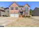 Beautiful two-story brick home with attached two car garage and manicured front yard at 536 Caledon Way, Hampton, GA 30228