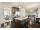 Kitchen island with granite countertops that overlooks an adjacent dining and living area at 536 Caledon Way, Hampton, GA 30228
