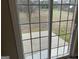 View through sliding glass doors to the backyard concrete patio at 305 Magnolia Gardens Walk, Mcdonough, GA 30253
