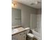 Bathroom with a single sink vanity, toilet, and a tub-shower combo with tiled walls at 305 Magnolia Gardens Walk, Mcdonough, GA 30253