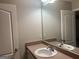 Bathroom with a single sink vanity, neutral walls, and modern fixtures at 305 Magnolia Gardens Walk, Mcdonough, GA 30253