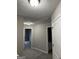 Upstairs hallway with carpet, neutral walls, and doors to multiple rooms at 305 Magnolia Gardens Walk, Mcdonough, GA 30253