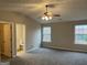 Spacious main bedroom featuring neutral walls, two windows, carpeted floor, and a ceiling fan at 305 Magnolia Gardens Walk, Mcdonough, GA 30253