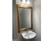 Powder room featuring a pedestal sink, a decorative gold mirror, and neutral walls at 305 Magnolia Gardens Walk, Mcdonough, GA 30253