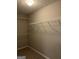 Walk-in closet with wall-mounted shelving providing ample storage space at 305 Magnolia Gardens Walk, Mcdonough, GA 30253