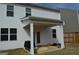 Back exterior featuring a cozy covered patio, grill and fenced backyard, ideal for outdoor living at 1879 Redfern Rd, Dacula, GA 30019
