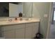 Bathroom featuring double sinks, marble countertop, and plenty of cabinet space at 1879 Redfern Rd, Dacula, GA 30019