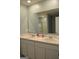 Bathroom featuring double sinks, large mirror, and a marble countertop at 1879 Redfern Rd, Dacula, GA 30019