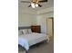 This is a bedroom featuring a bed and a wooden dresser and ceiling fan at 1879 Redfern Rd, Dacula, GA 30019
