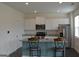 Modern kitchen featuring an island with barstool seating and stainless steel appliances at 1879 Redfern Rd, Dacula, GA 30019
