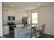 Modern kitchen with an island, granite counters, white cabinets, and stainless steel appliances at 1879 Redfern Rd, Dacula, GA 30019