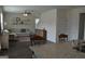 Open-concept living room with hardwood floors, floating shelves and a comfortable couch at 1879 Redfern Rd, Dacula, GA 30019
