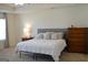 Bright bedroom featuring a comfortable bed, a side table, and a window at 1879 Redfern Rd, Dacula, GA 30019