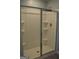 A streamlined walk-in shower featuring chrome hardware and built-in shelving at 1879 Redfern Rd, Dacula, GA 30019
