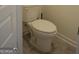 Modern bathroom with a standard toilet, and gray wood-look floors at 1879 Redfern Rd, Dacula, GA 30019